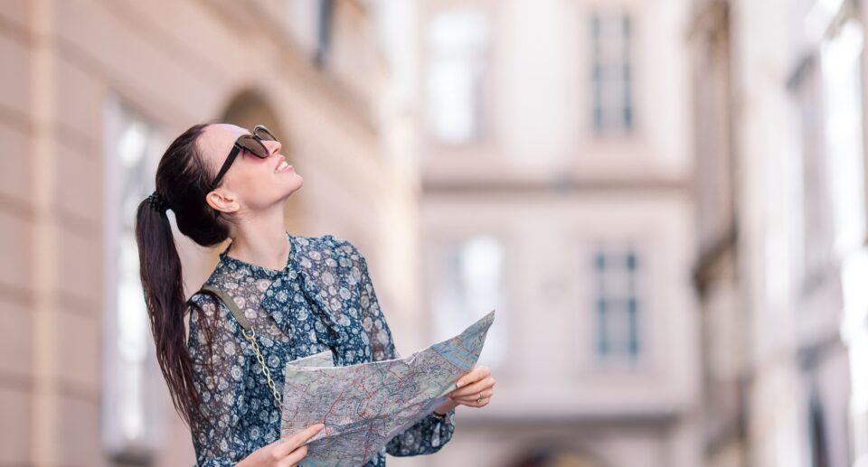 Travel tourist girl with map in Vienna outdoors during holidays in Europe